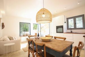 a kitchen and dining room with a table and chairs at TD Trulli Tortorella with Nature Pool Sauna in Monopoli +23 photos
