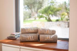 a pile of brown towels sitting on top of a window at TD Trulli Tortorella with Nature Pool Sauna in Monopoli