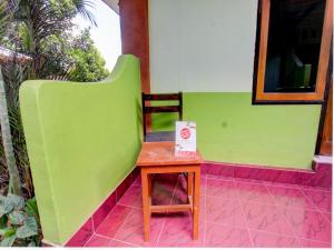 a small table with a box on it next to a house at OYO Life 92829 Kos Insan Madani in Praya
