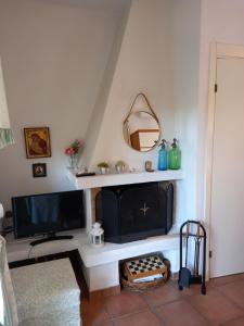 a living room with a tv and a fireplace at Siviri kassandras Xalkidiki, Experience Accomodation in Siviri