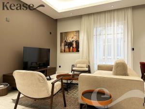 a living room with a couch and chairs and a tv at Kease King Salman G-1 Lusso Najd GX96 in Riyadh