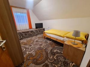 a bedroom with a bed and a lamp on a table at Uriges Landgasthaus in Modriach in Modriach