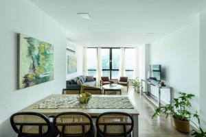 a living room with a table and chairs at Modern & Bright 3BR Apt by Sea N' Rent in Tel Aviv
