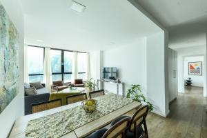 a dining room and living room with a table and chairs at Modern & Bright 3BR Apt by Sea N' Rent in Tel Aviv