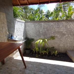 a bathroom with a sink and some plants at Villa Uma Ayu Sidemen in Sidemen