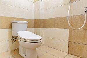 a bathroom with a toilet and a shower at OYO Life 92663 Karmel 6 in Purwokerto