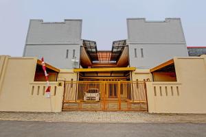 a building with a gate in front of it at OYO Life 92663 Karmel 6 in Purwokerto