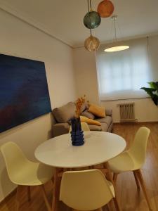 a living room with a table and chairs and a couch at Urbanlux Hospital II in Albacete