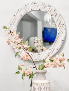 a vase with flowers in front of a mirror at 2bdrm Gaslamp Conv Cntr - W Parking & 4 Beds #1 in San Diego