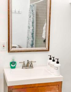 a bathroom with a sink and a mirror at 2bdrm Gaslamp Conv Cntr - W Parking & 4 Beds #1 in San Diego