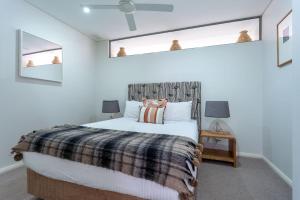 a bedroom with a bed and two mirrors at Dunn Bay Apartment 3 - Dunsborough in Dunsborough