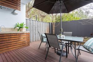 a patio with a table and chairs and an umbrella at Dunn Bay Apartment 3 - Dunsborough in Dunsborough