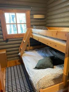 a bedroom with two bunk beds and a pillow on a bed at Rantahuvila Naantalissa in Naantali