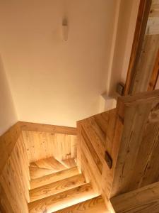 an empty room with wooden floors and a wooden door at Fior di Roccia Apartments in Breuil-Cervinia