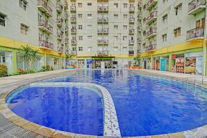 ein großer Pool in der Mitte eines Gebäudes in der Unterkunft OYO Life 92984 The Suites Metro Apartement By Echie Property in Bandung