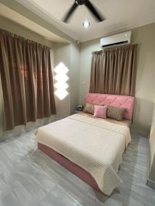 1 dormitorio con 1 cama grande y cabecero rosa en AR HOMESTAY KUALA TERENGGANU en Kuala Terengganu