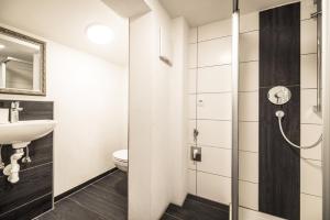 a bathroom with a sink and a toilet at Alpenzauber / Chalet AlmZeit / Almhütte Zillertal in Schwaz