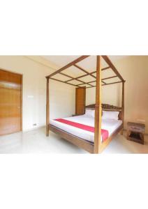 a bedroom with a bed with a wooden bed frame at Red Lotus Villa 5Bhk in Lonavala