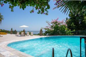 a swimming pool with a view of the ocean at Villa Grosse Sea and Mountains View in Gastouri