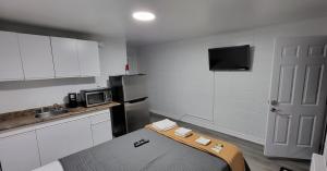 a small kitchen with a bed and a microwave at Happyland Inn in Orillia