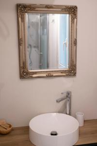 La salle de bains est pourvue d'un lavabo blanc et d'un miroir. dans l'établissement Home Holiday Rome - 2° Floor, à Rome