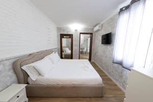 a bedroom with a bed and a television in it at Home Holiday Rome - 2° Floor in Rome +8 photos