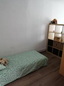 a dog laying on a bed in a bedroom at Pis amb grans vistes a Montserrat in Igualada