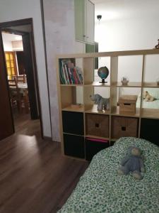 a bedroom with a teddy bear sitting on a bed at Pis amb grans vistes a Montserrat in Igualada
