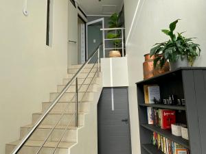 a staircase in a house with a book shelf at Rose’s Place in Cape Town