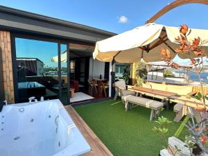 a bath tub sitting next to a table with an umbrella at HOFT Cihangir in Istanbul