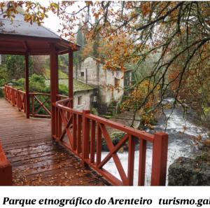 a wooden bridge with a gazebo next to a river at Piso Villa Aurora in Carballino