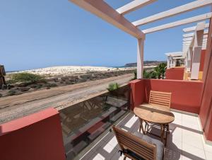 a balcony with a table and a view of the beach at Large Townhouse close to Beach in Sal Rei