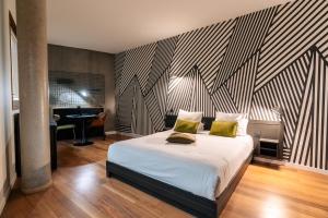 ein Schlafzimmer mit einem Bett mit zwei gelben Kissen darauf in der Unterkunft Cowool Lille Villeneuve D'Ascq - Ex Olivarius in Villeneuve d'Ascq