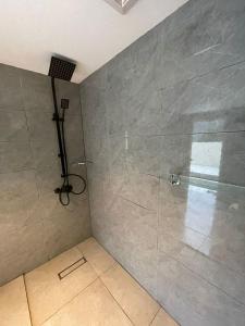 a bathroom with a shower with a glass door at Al Hada Hills Residential Unit in Al Hada