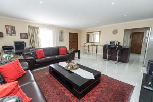 a living room with a couch and a table at Cosy Home In Bluewater Bay in Amsterdamhoek