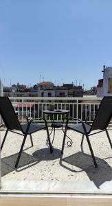 a table and two chairs sitting on a roof at Hygge Home at Trikala in Tríkala