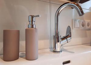 a kitchen sink with a faucet and two paper towels at Alpenzauber Apartment Montafon in Sankt Gallenkirch +61 photos
