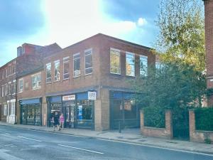 a brick building on the side of a street at Fountain Apartment No 2 with Free Parking in York