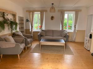 a living room with two couches and a coffee table at Gîte la belle etoile in Ver