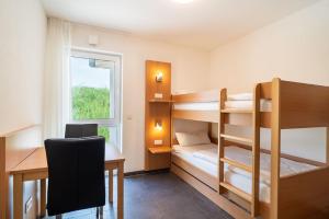 Postel nebo postele na pokoji v ubytování Feriendorf am Sonnensee