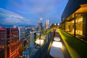 a view of a city skyline at night from a building at Klcc studio with a rooftop garden playground in Kuala Lumpur