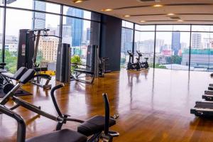 a gym with treadmills and exercise bikes in a building at Klcc studio with a rooftop garden playground in Kuala Lumpur