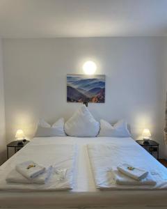 a large white bed with two towels on it at Hotel Starlight in Frankfurt/Main