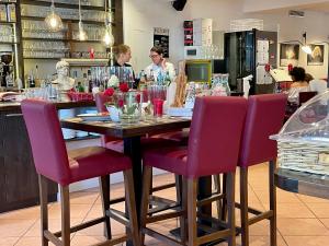 a table with purple chairs at a restaurant at Hotel Weinhaus Hoff in Bad Honnef am Rhein