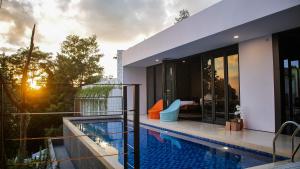 a house with a swimming pool on top of a building at MALLO VILLA - DAGO VILLAGE - NEW VILLA & FURNISH in Bandung