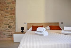 a bedroom with a large bed with towels on it at Ca' Ronzini in Castiglione Falletto
