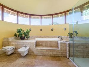 a bathroom with a tub and a toilet and a sink at The Oast House - Hartley Wine Estate in Alton