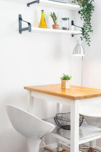 a white table with a white chair and a white desk at Elektoralna 19A by Homeprime in Warsaw