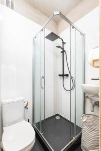 a bathroom with a shower with a toilet and a sink at Elektoralna 19A by Homeprime in Warsaw