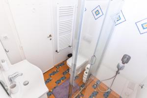 a small bathroom with a toilet and a sink at Ugi house - City Center in Belgrade